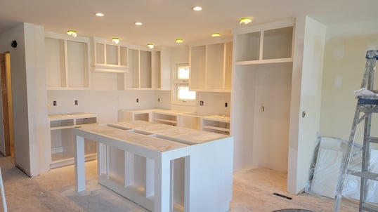 Freshly sprayed white kitchen cabinet boxes.