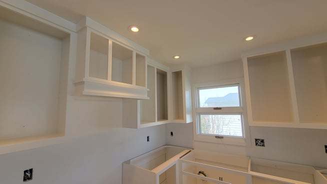 Cabinet boxes sprayed white inside a kitchen.