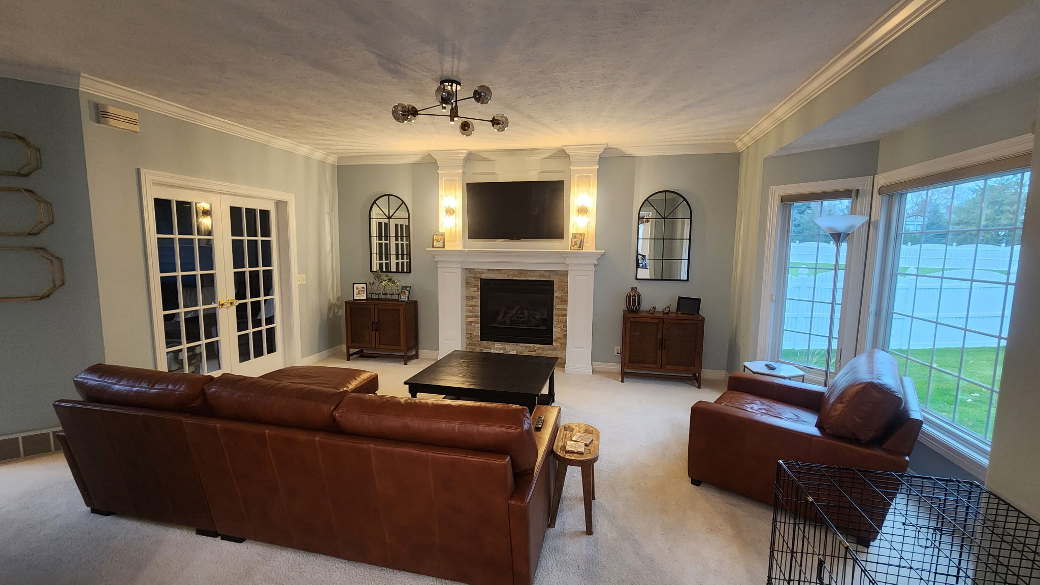 Living room walls painted a light blue color and ceiling painted white with white trim inside of a home in Omaha, NE.