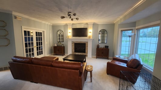Living room painted a soft baby blue color with white trim and ceiling.