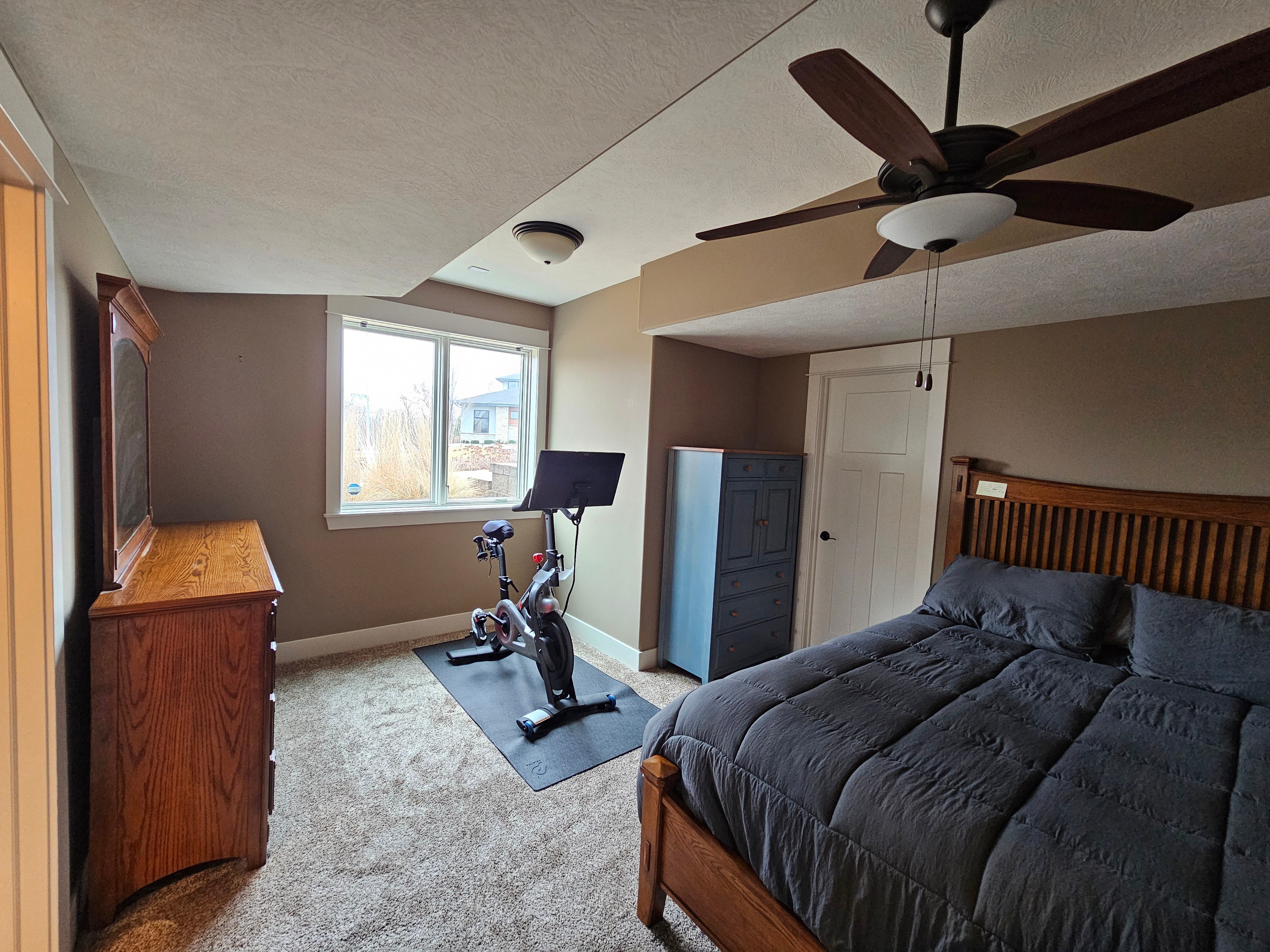 Interior bedroom painted a warm brown color with white trim.
