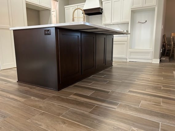 Kitchen island painted black with white cabinets surrounding the space in papillion.
