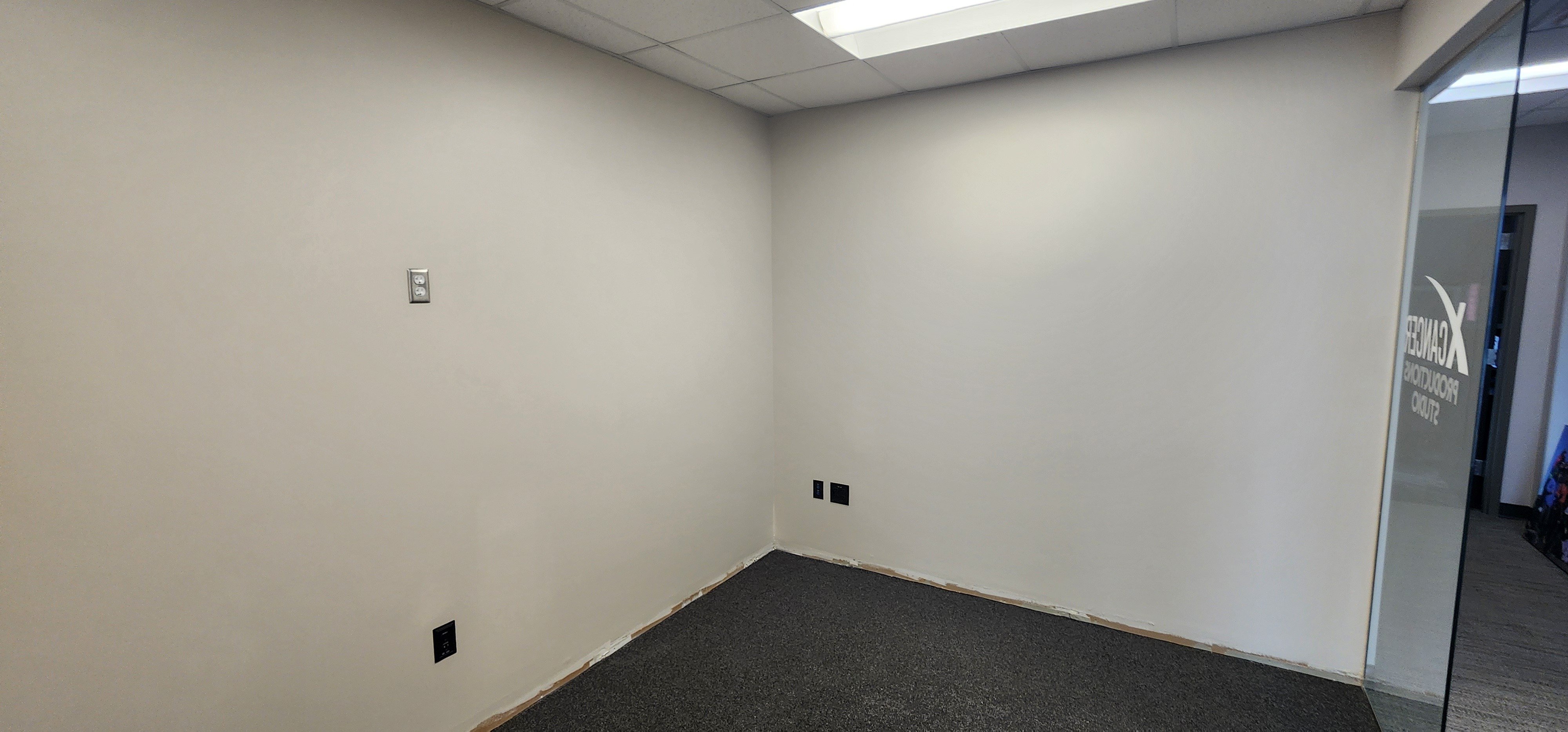 Room with freshly painted cool off white walls inside a office in Omaha, NE.