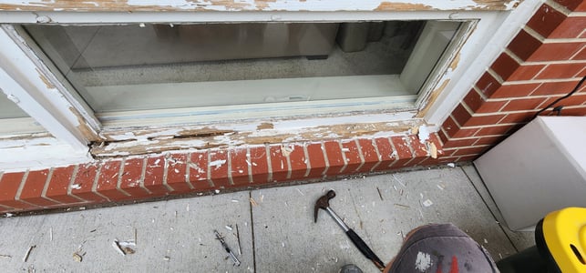 Damaged and peeling paint on a window trim on the outside of a home in Omaha.