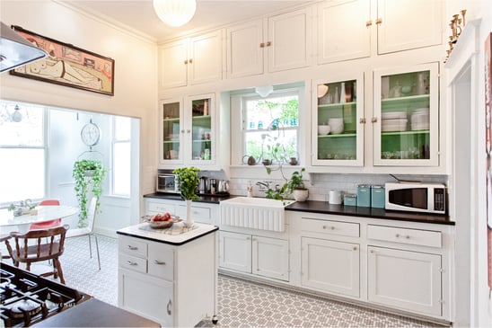 Kitchen with white walls and cabinets