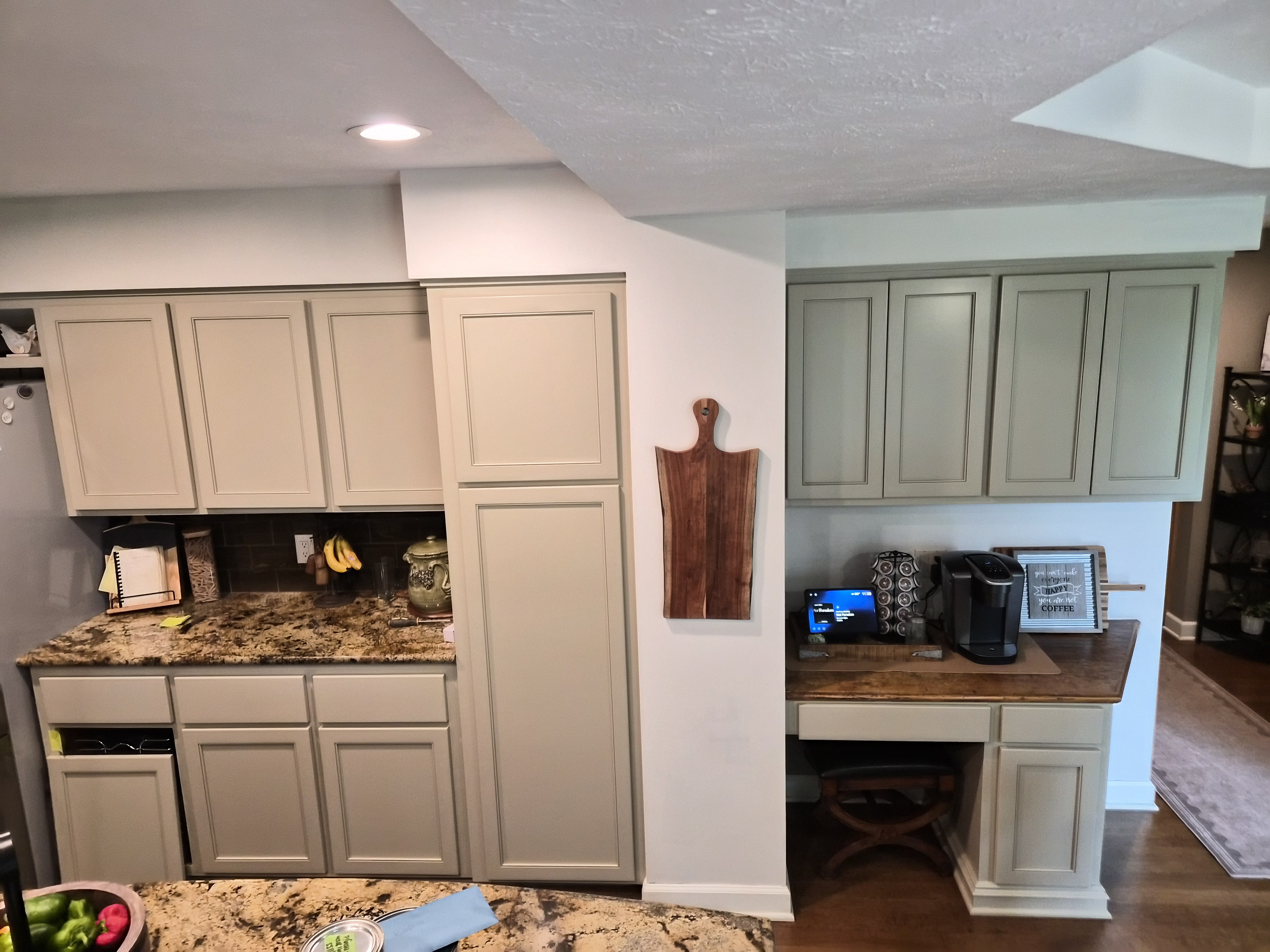 Kitchen cabinets painted a cool toned beige color with no handles installed in a home in Bennington, NE.