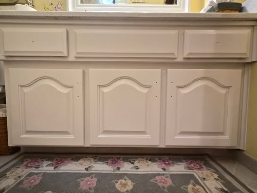 Cabinet vanity in bathroom painted white with no handles in omaha, NE.