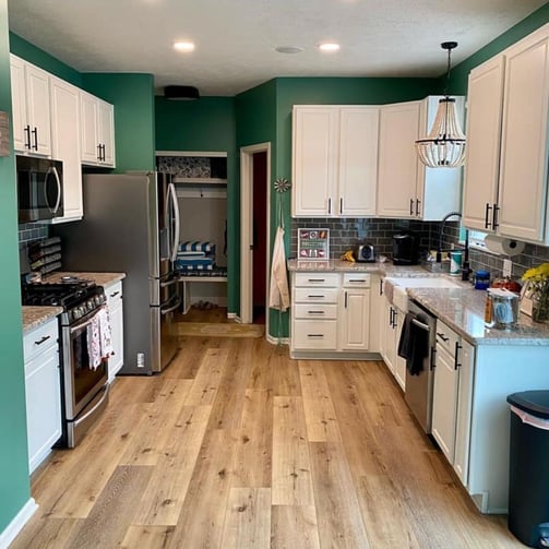 Green kitchen walls with white cabinets
