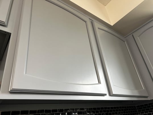 Cabinet doors and boxes painted a light grey color.