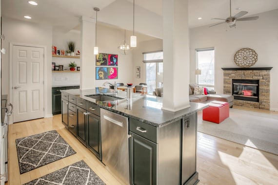 Kitchen and living room with walls and cabinets freshly painted. Greenblack,