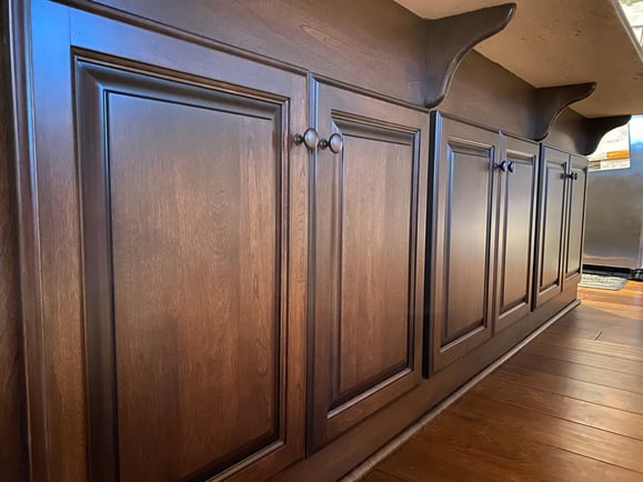 Stained cabinet island in a kitchen.