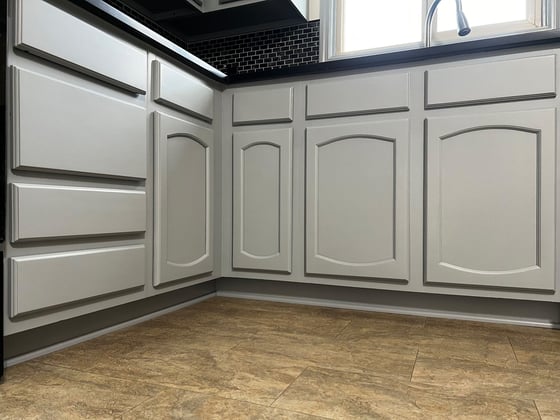 Lower cabinet doors painted a light grey color inside a kitchen in Omaha, NE.