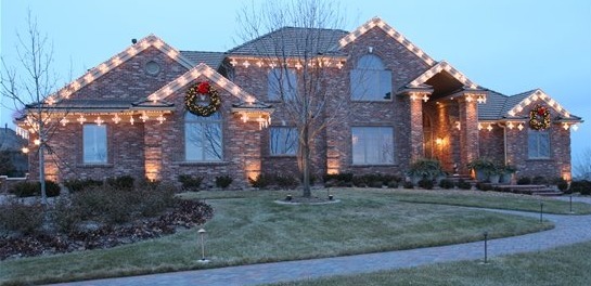 Classy christmas lights in a warm white color on a brick home.