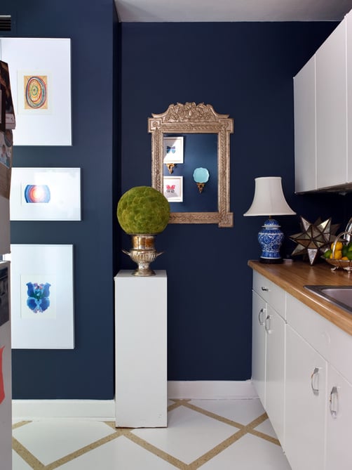 Navy blue walls with white kitchen cabinets