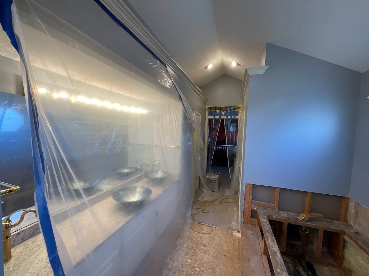 Plastic sheeting put up inside of a bathroom to protect the vanity from paint.