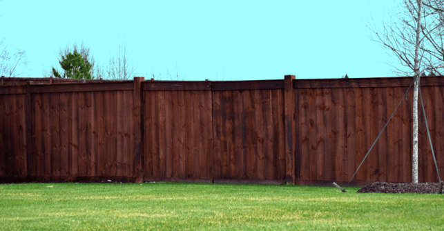 Wood fence with a dark brown stain in Omaha, NE.