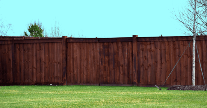 Wood fence that was stained a deep dark brown around a house in Omaha, NE.