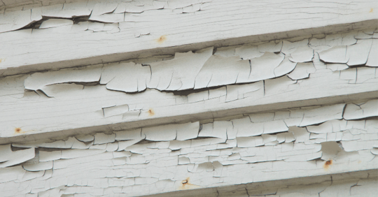 White exterior paint siding chipping badly.