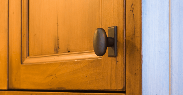 Golden oak distressed cabinet door with a oil rubbed bronze knob.