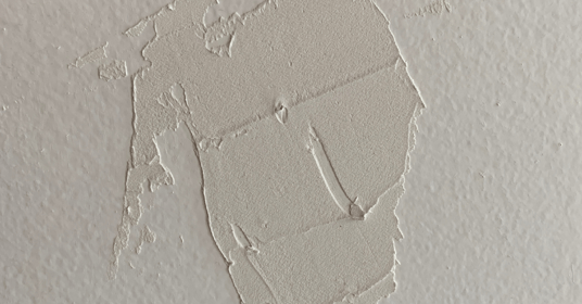 Plaster or drywall repair on a wall that was painted white.