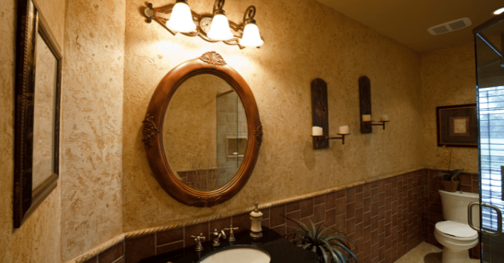 Bathroom with light beige walls with a thick faux finish deisgn.