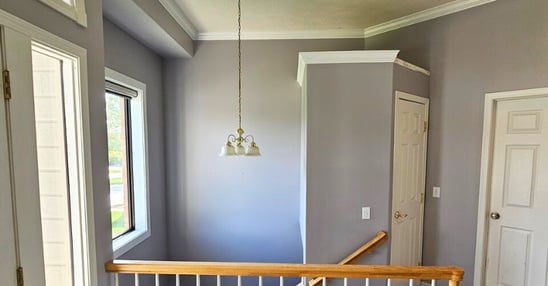 Entryway staircase with freshly painted walls and white trim in Omaha, NE.