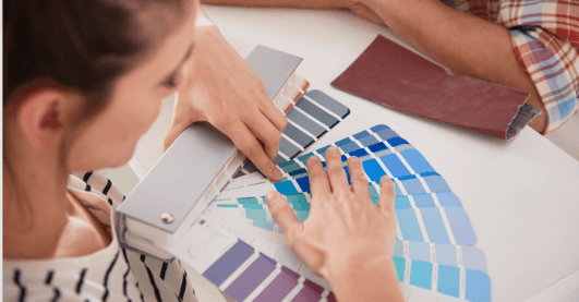 Homeowners picking out a paint color for their home painting project in Omaha.