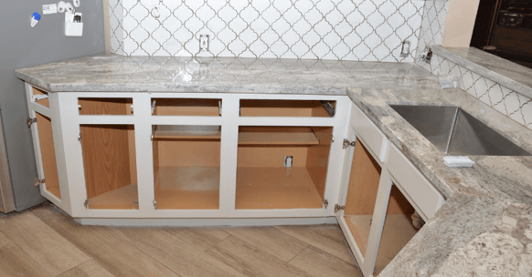 White painted laminate cabinet boxes with doors and drawers removed.