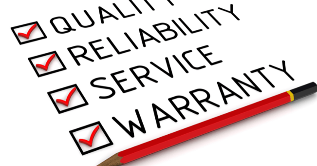 "Quality, reliability, service, and warranty" types on a paper with check marks.