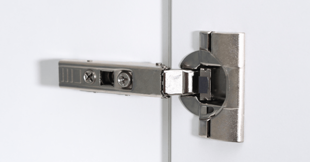 Close up of soft close hinge on a cabinet door.