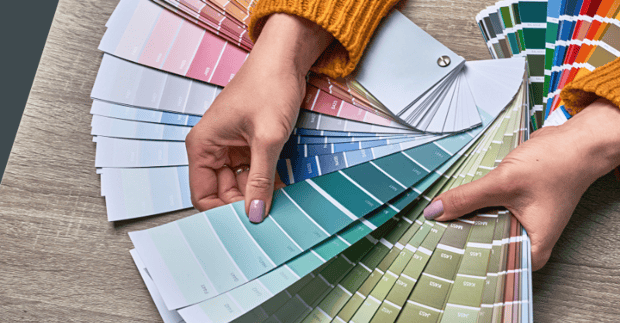 Color swatch laid out on a table showing blue and green paint shades.