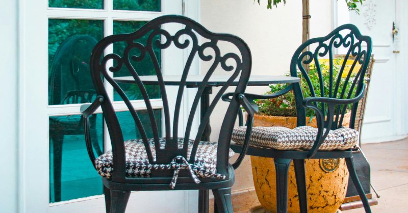 Black outdoor painted metal patio table and chairs.