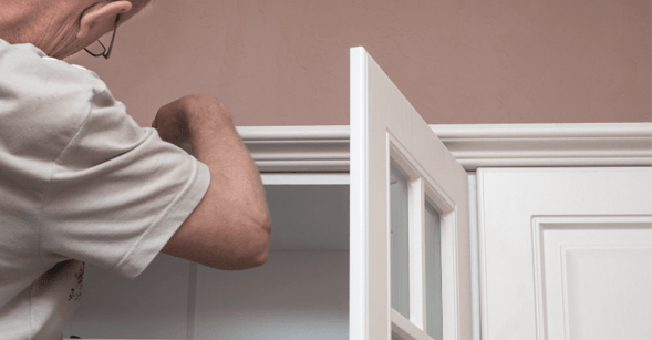 Man replacing the trim around a closet door in Omaha, NE
