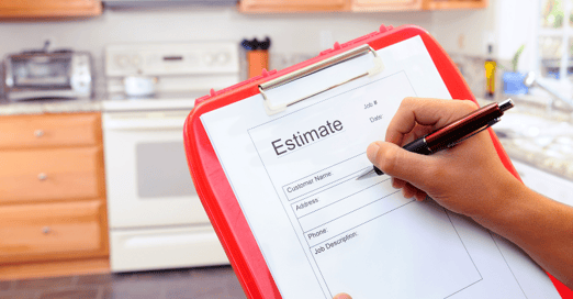 Person in a kitchen writing on a clipboard a painting quote/estimate for hiring a painter.