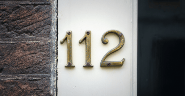 Number "112" on exterior of home in gold.