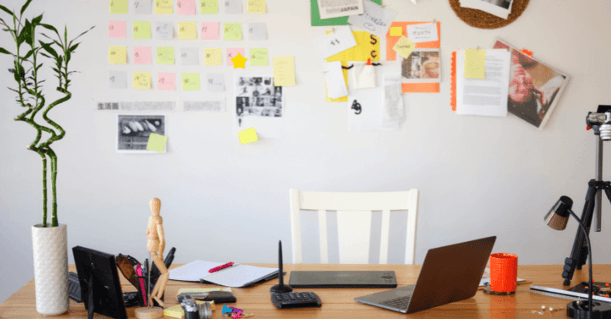 Home office with magnetic wall and papers attached.