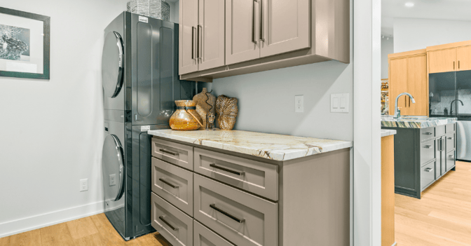 Cabinets painted a light beige brown color in a laundry room inside a home in Omaha, NE.
