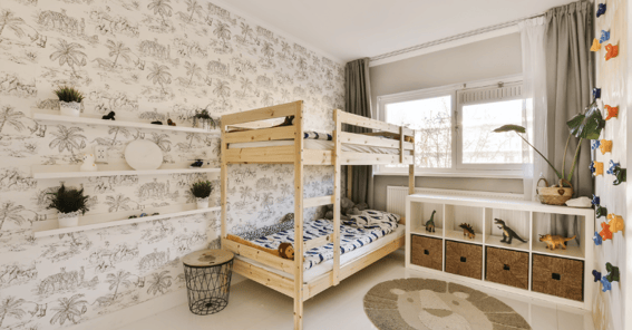Kids room with wallpaper and bunkbeds.