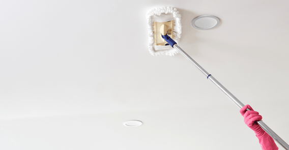 Person cleaning ceiling with mop.