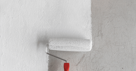 White paint being rolled on to a wall.