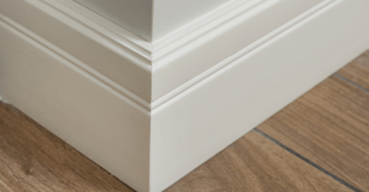 Corner of baseboard painted white