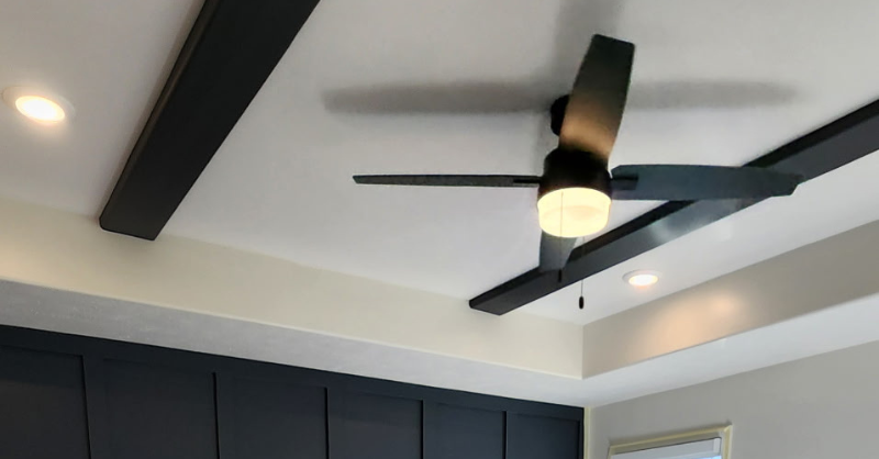 Bedroom ceiling with beams painted black.