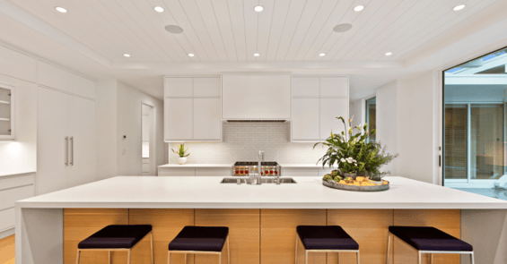 Bright white kitchen with recessed lights painted white with ceiling.