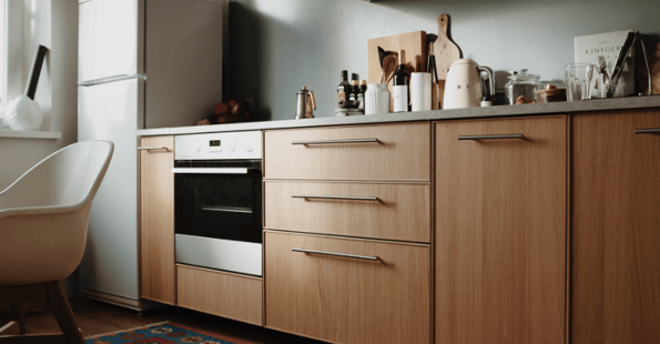 Kitchen lower cabinets with mdf wood and large silver handles.