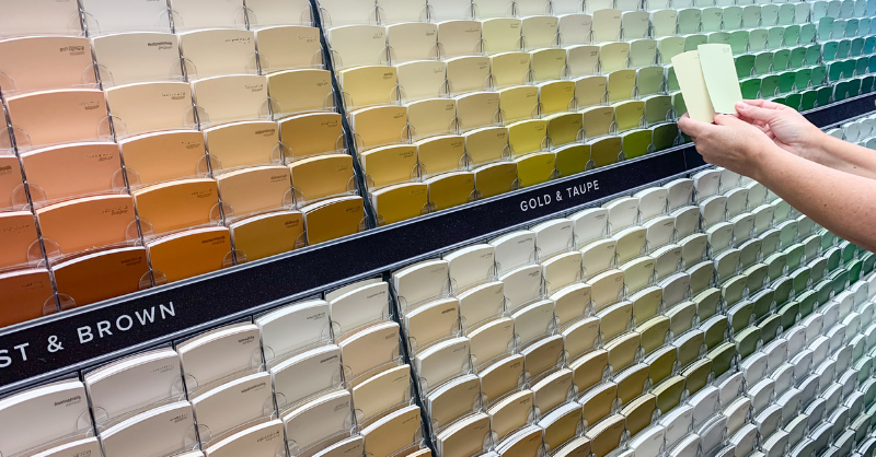 Wall of paint color swatches in a hardware store for homeowners to pick paint colors in Omaha, NE.