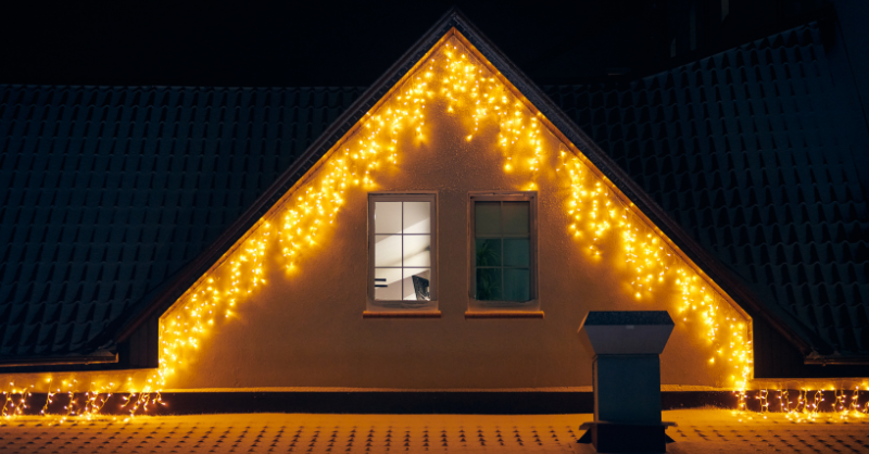 Christmas icicle lights hung on the peak of a house in a warm white color in Omaha.