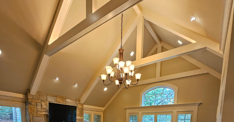Walls and ceilings painted a warm beige color with white beams and trim for accent color inside a living room in Council Bluffs, IA.