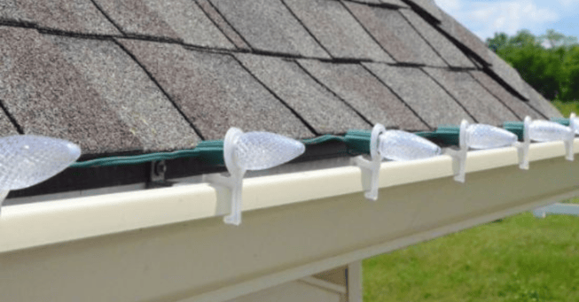 Professionally installed c9 christmas light bulbs on the roofline of a house in Omaha.