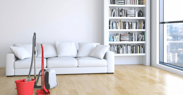 Living room with cleaning supplies in the middle and white paint on the walls.