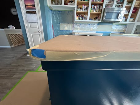 Paper over countertop and on floor while a cabinet painting project is happening.